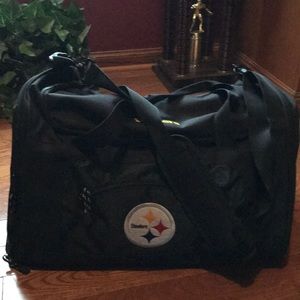 Int. pocket torn,duffle approx 20in,handle, strap